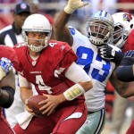 Arizona Cardinals quarterback Kevin Kolb (4) scrambles as Dallas Cowboys outside linebacker Anthony Spencer (93) pursues during the first half of an NFL football game, Sunday, Dec. 4, 2011, in Glendale, Ariz. (AP Photo/Ross D. Franklin)