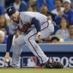 Atlanta Braves first baseman Freddie Freeman grabs a single by Los Angeles Dodgers' Skip Schumaker, in the fourth inning of Game 4 in the National League baseball division series Monday, Oct. 7, 2013, in Los Angeles. (AP Photo/Danny Moloshok)