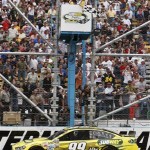Carl Edwards takes the checkered flag to win the NASCAR Sprint Cup Series auto race, Sunday, March 3, 2013, in Avondale, Ariz. (AP Photo/Ross D. Franklin)