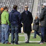John Elway, center, executive vice president of football operations for the Denver Broncos, looks around MetLife Stadium before the team's walk-through Saturday, Feb. 1, 2014, in East Rutherford, N.J. The Broncos are scheduled to play the Seattle Seahawks in the NFL Super Bowl XLVIII football game Sunday. (AP Photo/Mark Humphrey)