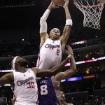 Los Angeles Clippers' Kenyon Martin, top center, dunks over Phoenix Suns' Channing Frye as teammate Reggie Evans, left, watches during the second half of an NBA basketball game in Los Angeles, Thursday, March 15, 2012. The Suns won 91-87. (AP Photo/Jae C. Hong)