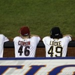 National League players watch from the dugout during the sixth inning of the MLB All-Star baseball game, on Tuesday, July 16, 2013, in New York. (AP Photo/Julio Cortez)