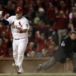 St. Louis Cardinals' Matt Adams celebrates after scoring during the fifth inning of Game 6 of the National League baseball championship series against the Los Angeles Dodgers Friday, Oct. 18, 2013, in St. Louis. (AP Photo/Jeff Roberson)