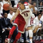 Arizona's Nick Johnson (13) tries to steal the ball away from UNLV's Kevin Olekaibe in the first half of an NCAA college basketball game on Saturday, Dec. 7, 2013, in Tucson, Ariz. (AP Photo/John MIller)
