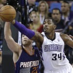  Phoenix Suns center Miles Plumlee, left, tries to steal the pass intended for Sacramento Kings forward Jason Thompson during the first quarter of an NBA basketball game in Sacramento, Calif., Tuesday, Nov. 19, 2013.(AP Photo/Rich Pedroncelli)