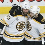 Boston Bruins defenseman Zdeno Chara (33) is congratulated by Boston Bruins center David Krejci (46) after scoring a goal against the Chicago Blackhawks in the third period during Game 5 of the NHL hockey Stanley Cup Finals, Saturday, June 22, 2013, in Chicago. (AP Photo/Charles Rex Arbogast)
