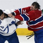 Toronto Maple Leafs defenseman Mark Fraser, left, fights with Montreal Canadiens left wing Travis Moen (32) during second period of an NHL hockey game on Tuesday, Oct. 1, 2013, in Montreal. (AP Photo/The Canadian Press, Ryan Remiorz)
