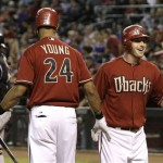 Arizona Diamondbacks' Stephen Drew, right, smiles as he celebrates his home run against the Colorado Rockies with teammate Chris Young (24) as Rockies catcher Miguel Olivo, left, looks away during the first inning of a baseball game Wednesday, Sept. 22, 2010, in Phoenix. (AP Photo/Ross D. Franklin)