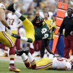 Green Bay Packers' James Starks is tripped up on a run during the second half of an NFL football game against the Washington Redskins Sunday, Sept. 15, 2013, in Green Bay, Wis. (AP Photo/Tom Lynn)