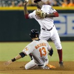 Baltimore Orioles' Manny Machado (13) is forced out by Arizona Diamondbacks' Didi Gregorious as he turns a double play on Adam Jones during the first inning, Monday, Aug. 12, 2013, in Phoenix. (AP Photo/Matt York)
