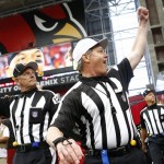 Officials respond to cheers from the crowd as they arrive to work the NFL football game between the Miami Dolphins and the Arizona Cardinals on Sunday, Sept. 30, 2012, in Glendale, Ariz. NFL officials ended their labor dispute with the league by approving a new eight-year contract with a 112-5 vote Saturday, then hustled off to the airport to get to work. (AP Photo/The Arizona Republic, Rob Schumacher)