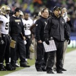 New Orleans Saints head coach Sean Payton, second from right, watches from the sideline in the first half of an NFL football game against the Seattle Seahawks, Monday, Dec. 2, 2013, in Seattle. (AP Photo/Scott Eklund)