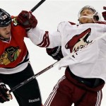  Phoenix Coyotes' Rob Klinkhammer, right, is hit by Chicago Blackhawks' Bryan Bickell during the third period of an NHL hockey game in Chicago, Thursday, Nov. 14, 2013. The Blackhawks won 5-4. (AP Photo/Nam Y. Huh)