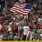 Fans wave an American Flag during an Arizona Diamondbacks and Texas Rangers interleague baseball game, Monday, May 27, 2013, in Phoenix. The Diamondbacks won 5-3. (AP Photo/Matt York)