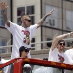 Miami Heat's Chris Andersen, center, gestures during the celebration parade as teammate Mike Miller, right, waves to the fans in Miami, Monday, June 24, 2013. The Heat became the sixth franchise in NBA basketball history to win consecutive championships, after topping the San Antonio Spurs in this year's finals for the third title overall for the Heat franchise. (AP Photo/Javier Galeano)