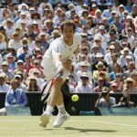 Andy Murray of Britain stretches for a return by Novak Djokovic of Serbia during the Men's singles final match at the All England Lawn Tennis Championships in Wimbledon, London, Sunday, July 7, 2013. (AP Photo/Kirsty Wigglesworth)
