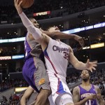 Los Angeles Clippers' Blake Griffin, right, is fouled by Phoenix Suns' Ronnie Price during the second half of an NBA basketball game in Los Angeles, Thursday, March 15, 2012. The Suns won 91-87. (AP Photo/Jae C. Hong)