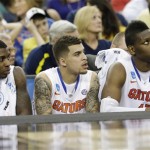 From left, Florida's Casey Prather, Scottie Wilbekin and Will Yeguete, watch action against Michigan during the second half of a regional final game in the NCAA college basketball tournament, Sunday, March 31, 2013, in Arlington, Texas. (AP Photo/Tony Gutierrez)