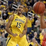  Michigan forward Jon Horford (15) reacts after making a basket during the first half of an NCAA college basketball game against Arizona in Ann Arbor, Mich., Saturday, Dec. 14, 2013. (AP Photo/Carlos Osorio)