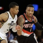 Team Hill's Damian Lillard of the Portland Trail Blazers, right, moves the ball against Team Webber's Trey Burke of the Utah Jazz during the Rising Star NBA All Star Challenge Basketball game, Friday, Feb. 14, 2014, in New Orleans. (AP Photo/Gerald Herbert)