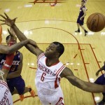  Houston Rockets' Terrence Jones (6) looses the ball as Phoenix Suns' Channing Frye (8) defends during the first quarter of an NBA basketball game Wednesday, Dec. 4, 2013, in Houston. (AP Photo/David J. Phillip)