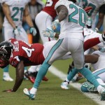 Atlanta Falcons fullback Jason Snelling (44) jumps into the end zone for a touchdown during the first half of an NFL football game against the Miami Dolphins, Sunday, Sept. 22, 2013, in Miami Gardens, Fla. To the right is Dolphins free safety Reshad Jones (20). (AP Photo/Wilfredo Lee)