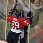 Chicago Blackhawks' Bryan Bickell (29) crashes into the boards while celebrating his game-winning goal against the Minnesota Wild during overtime in Game 1 of an NHL hockey Stanley Cup playoff series Tuesday, April 30, 2013, in Chicago. The Blackhawks defeated the Wild 2-1. (AP Photo/Jim Prisching)