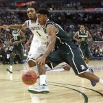 Michigan State guard Gary Harris drives on Kentucky guard James Young (1) during the second half of an NCAA college basketball game Tuesday, Nov. 12, 2013, in Chicago. Michigan State won 78-74. (AP Photo/Charles Rex Arbogast)