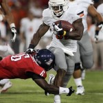 Oklahoma States' Jeremy Smith (31) runs through an attempted tackle from Arizona's Jonathan McKnight (6) during the first half of an NCAA college football game at Arizona Stadium in Tucson, Ariz., Saturday, Sept. 8, 2012. (AP Photo/John Miller)

