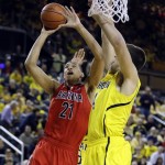  Arizona forward Brandon Ashley (21) makes a lay-up defended by Michigan forward Mitch McGary (4) during the second half of an NCAA college basketball game in Ann Arbor, Mich., Saturday, Dec. 14, 2013. (AP Photo/Carlos Osorio)