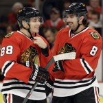  Chicago Blackhawks' Patrick Kane, left, smiles as he talks with Nick Leddy (8) during the first period of an NHL hockey game against the Phoenix Coyotes in Chicago, Thursday, Nov. 14, 2013. (AP Photo/Nam Y. Huh)