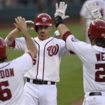 Washington Nationals' Adam LaRoche, center, is greeted by teammates Anthony Rendon (6) and Jayson Werth (28) after hitting a three-run home run against the Arizona Diamondbacks during the third inning of a baseball game at Nationals Park in Washington, Tuesday, June 25, 2013. (AP Photo/Susan Walsh)