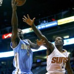 Denver Nuggets point guard Ty Lawson (3), left, drives past Phoenix Suns point guard Eric Bledsoe (2) in the first quarter during an NBA basketball game on Friday, Nov. 8, 2013, in Phoenix. (AP Photo/Rick Scuteri)
