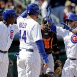 Chicago Cubs' Dioner Navarro is congratulated by Anthony Rizzo (44) and Alfonso Soriano after hitting a three-run home run during an exhibition spring training baseball game against the San Francisco Giants, Sunday, Feb. 24, 2013, in Mesa, Ariz. (AP Photo/Morry Gash)