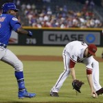 Arizona Diamondbacks' Patrick Corbin, right, fields a ground ball hit by Chicago Cubs' Alfonso Soriano during the first inning of a baseball game Tuesday, July 23, 2013, in Phoenix. Soriano was out on the play. (AP Photo/Ross D. Franklin)