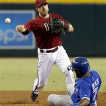 Arizona Diamondbacks' Willie Bloomquist, left, forces out Toronto Blue Jays' Jose Reyes (7) before throwing to first base to get Ryan Goins out for a double play in the sixth inning of a baseball game, on Wednesday, Sept. 4, 2013, in Phoenix. (AP Photo/Ross D. Franklin)