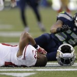  San Francisco 49ers' LaMichael James lays on the field after being hit on a punt return during the first half of the NFL football NFC Championship game against the Seattle Seahawks, Sunday, Jan. 19, 2014, in Seattle. (AP Photo/Marcio Jose Sanchez)