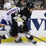New York Islanders' Andrew MacDonald (47) collides with Pittsburgh Penguins' Tanner Glass (15) in the second period of Game 2 of an NHL hockey Stanley Cup first-round playoff series, Friday, May 3, 2013, in Pittsburgh. (AP Photo/Gene J. Puskar)