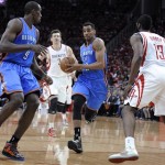 Oklahoma City Thunder's Thabo Sefolosha (2) drives to the basket between teammate Serge Ibaka (9) and Houston Rockets' Omer Asik (3) and James Harden (13) in the first quarter of Game 6 in a first-round NBA basketball playoff series Friday, May 3, 2013, in Houston. (AP Photo/Pat Sullivan)
