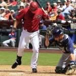 Milwaukee Brewers' Jonathan Lucroy, right, loses the ball as Arizona Diamondbacks' Jason Kubel tries to get out of the way during the third inning of an exhibition baseball game Wednesday, April 4, 2012, in Phoenix.(AP Photo/Ross D. Franklin)