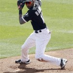 Chicago White Sox shortstop Alexei Ramirez checks the runner on third before spinning and throwing to first base to force out Los Angeles Dodgers' Juan Rivera in the second inning of a spring training baseball game, Monday, March 5, 2012, in Glendale, Ariz. (AP Photo/Paul Connors)