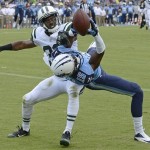 Tennessee Titans wide receiver Justin Hunter (15) catches a 16-yard touchdown pass as he is defended by New York Jets cornerback Darrin Walls (30) in the second quarter of an NFL football game on Sunday, Sept. 29, 2013, in Nashville, Tenn. (AP Photo/Mark Zaleski)