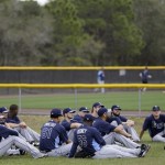 Tampa Bay Rays manager Joe Maddon, second from right, meets with pitchers during a break in a spring training baseball workout Thursday, Feb. 14, 2013, in Port Charlotte, Fla. (AP Photo/Chris O'Meara)