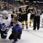 Toronto Maple Leafs center Mikhail Grabovski (84) is checked by a team trainer after a hard hit from Boston Bruins defenseman Johnny Boychuk (55) during the third period in Game 1 of a first-round NHL hockey playoff series in Boston, Wednesday, May 1, 2013. The Bruins won 4-1. (AP Photo/Elise Amendola)