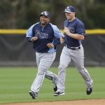 Tampa Bay Rays catchers Jose Molina, left, and Chris Gimenez laugh as they run during a baseball spring training workout Thursday, Feb. 14, 2013, in Port Charlotte, Fla. (AP Photo/Chris O'Meara)