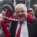 Toronto Mayor Rob Ford celebrates with hockey fans in Toronto's Maple Leaf Square after the final buzzer as Canada beat Sweden 3-0 to win the gold medal in the men's Olympic Hockey Final on Sunday, Feb. 23, 2014. (AP Photo/The Canadian Press, Chris Young)