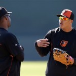 Baltimore Orioles third baseman Manny Machado, right, talks with teammate Wilson Betemit before a spring training baseball game against the Toronto Blue Jays, Thursday, March 7, 2013, in Sarasota, Fla. (AP Photo/Charlie Neibergall)