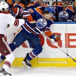  Phoenix Coyotes' Martin Hanzal (11) checks Edmonton Oilers' Ryan Jones (28) during the first period of an NHL hockey game in Edmonton, Alberta, on Tuesday, Dec. 3, 2013. (AP Photo/The Canadian Press, Jason Franson)