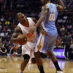 Phoenix Suns point guard Eric Bledsoe (2), left, reacts after getting fouled by Denver Nuggets power forward Darrell Arthur (00) in the third quarter during an NBA basketball game on Friday, Nov. 8, 2013, in Phoenix. The Suns defeated the Nuggets 114-93. (AP Photo/Rick Scuteri)
