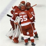 Detroit Red Wings goalie Jimmy Howard celebrates with Niklas Kronwall (55), of Sweden, Daniel Cleary (11) and Henrik Zetterberg after beating the Anaheim Ducks 3-2 in overtime of Game 4 of a first-round NHL hockey Stanley Cup playoff series in Detroit, Monday, May 6, 2013. (AP Photo/Paul Sancya)